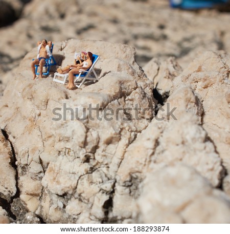 Miniature couple an a beach in swimming costume