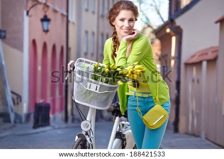 Fashionable woman with a bicycle on the streets of old Paris