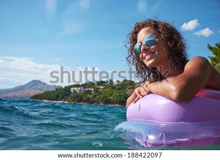 Gorgeous scenic view of young girl sunbathing on Adriatic waters in Croatia