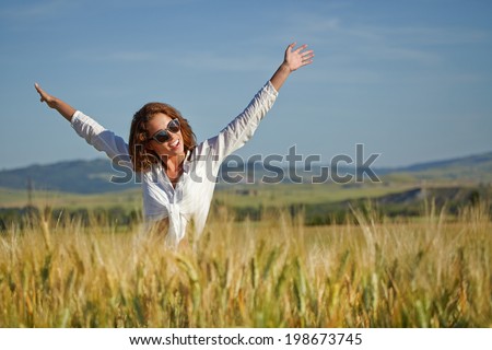 Woman in wheat field enjoying, freedom concept