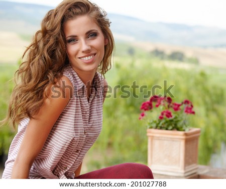 Beautiful woman on the terrace of an Italian country house
