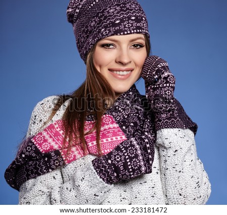 beautiful woman in warm clothing on blue background