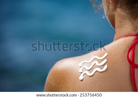 Woman With Suntan Lotion At The Beach In Form Of The wave