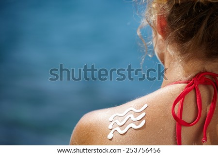 Woman With Suntan Lotion At The Beach In Form Of The wave