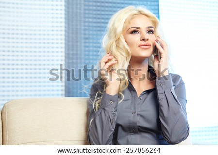 smiling woman looks to the side as she makes a call.