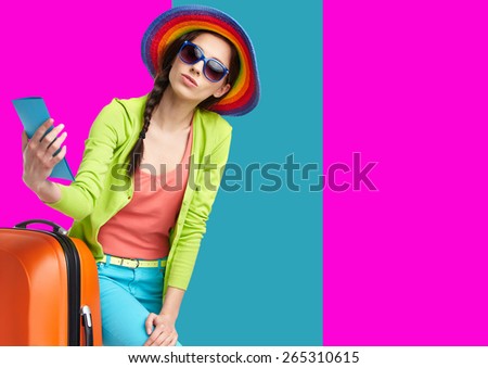 Woman tourist with travel suitcase and blue boarding pass, isolated on summer background