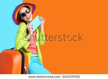 Woman tourist with travel suitcase and blue boarding pass, isolated on summer background