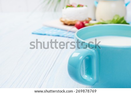 mug with milk on vintage table