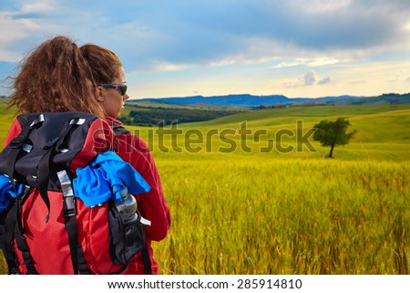 Female hiking woman happy and smiling during hike trek on Toscana hills