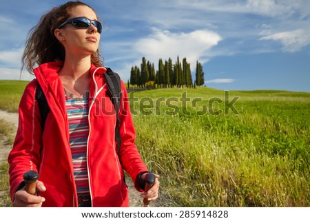 Female hiking woman happy and smiling during hike trek on Toscana hills