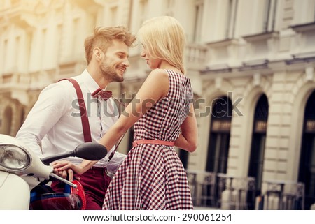 Young funny pretty fashion vintage hipster couple having fun outdoor on the street in summer.