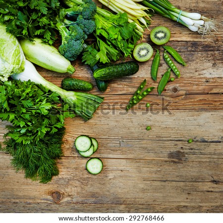 Raw detox green vegetable food set on wood table