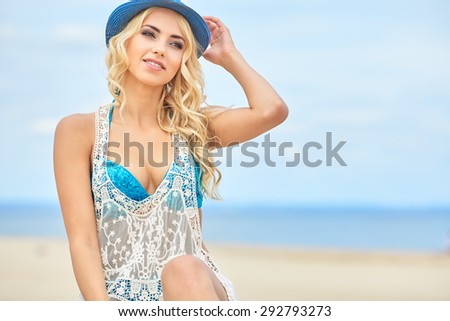 Beautiful girl relaxing and smiling outdoor at summer beach