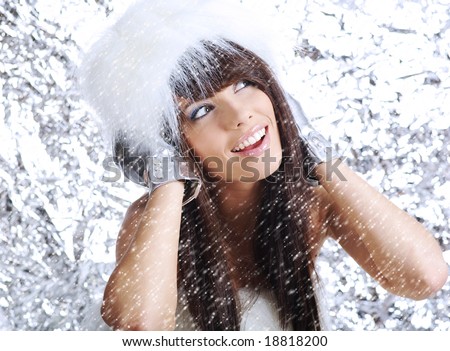 Winter Girl with beautiful make up, silver gloves and snow flake, silver background