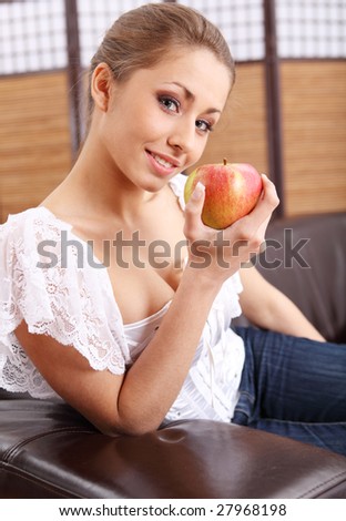 Young beautiful woman eating green apple
