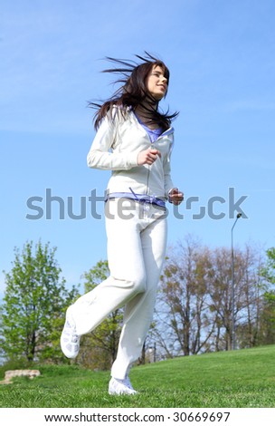 Sporting young woman running outdoor