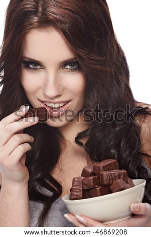 stock-photo--beauty-portrait-of-a-cute-brunette-girl-in-act-to-eat-a-chocolate-candy-46869208.jpg