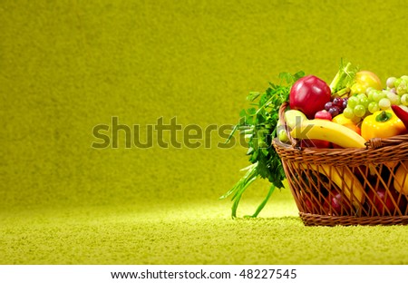 basket full of fresh produce. green background