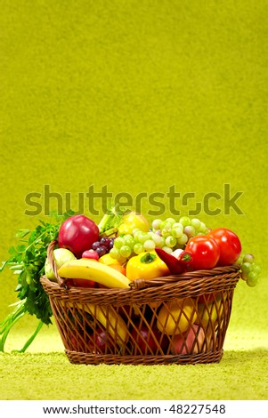 basket full of fresh produce. green background