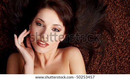 coffee beans on the hair of beautiful young woman