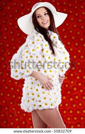 Spring woman dressed flower coat posing  on flowers background