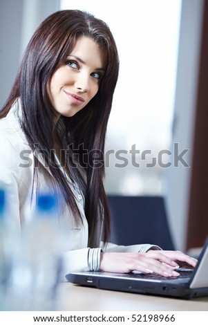 Portrait of happy young business woman in office