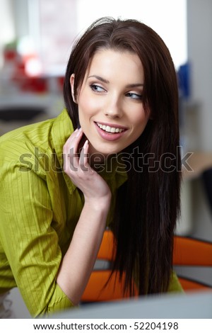Beautiful smiling business woman sitting and relaxing in the office