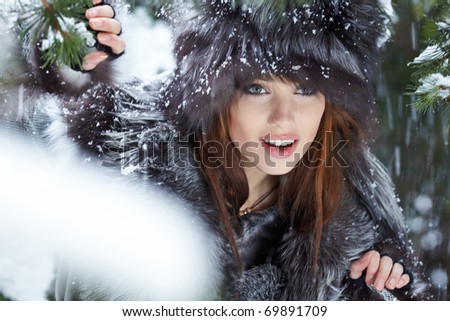Beautiful young woman in winter forest