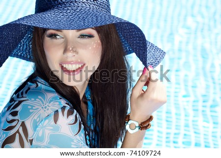 Beautiful natural woman smiling in pool on summer vacations.