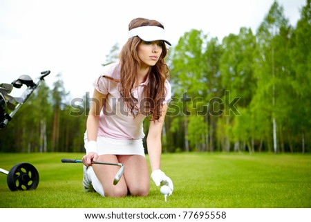 Young woman playing golf in a country club
