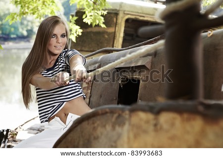 Sexy sailor woman on a ship wreck