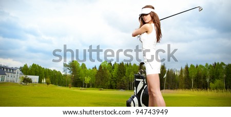 Portrait of an elegant woman playing golf on a green woman