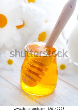 fresh honey in the glass bank and milk in jug