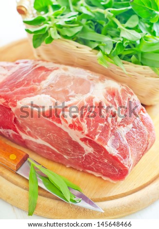 raw meat and knife on the wooden board