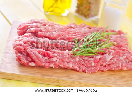 Minced meat in butcher paper with onion and garlic