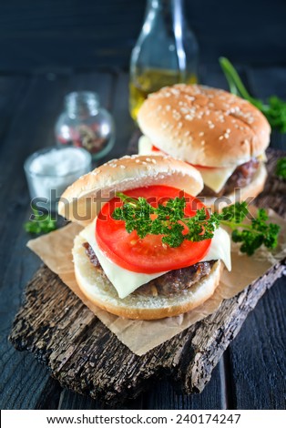 two cheeseburgers with selective focus on the foreground burger