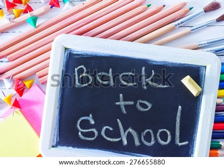 school supplies and black board on a table