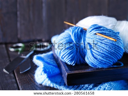 knitting on wooden tray and on a table