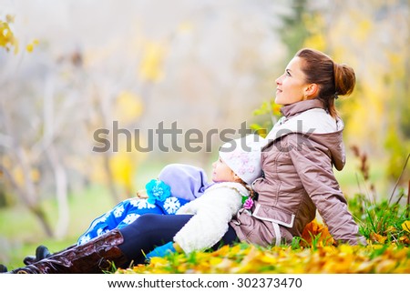 mother and sisters in autumn park