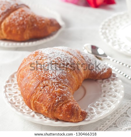 Coffee and croissant for breakfast, square image