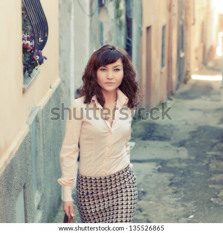 Attractive young woman in the small italian city, retro style