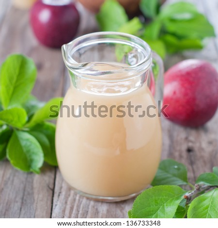 Fresh apple juice on the wooden table
