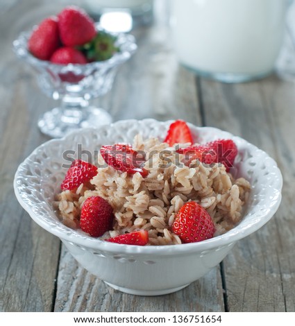 Healthy breakfast with oatmeal, milk and strawberry, square image