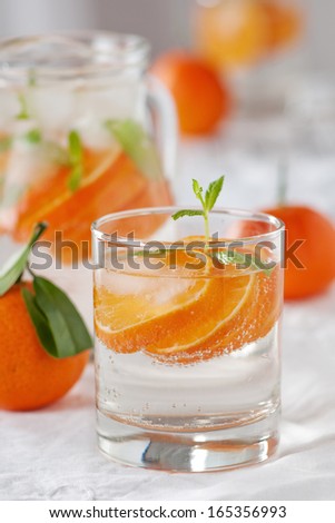 Orange mojito with rum, mint and tangerines