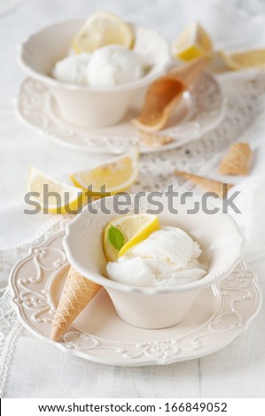 Ice-cream with lemon on the table, selective focus
