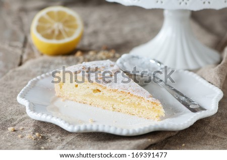 Homemade lemon cake with cream and fresh lemon, selective focus