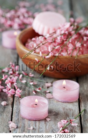 Spa with pink salt, flowers, candles and soap, selective focus
