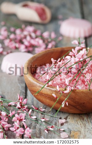 Spa with pink salt, flowers and soap, selective focus
