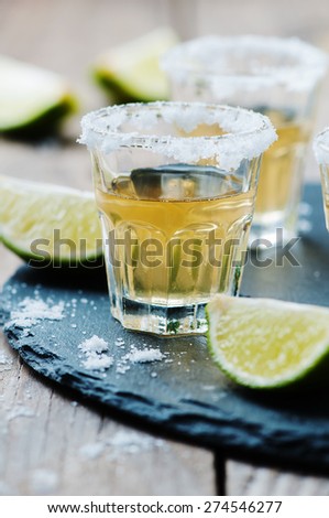 Gold tequila with lime and salt, selective focus