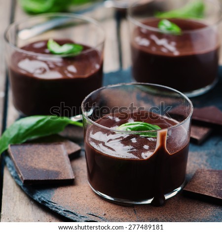 Chocolate mousse with basil, selective focus and square image